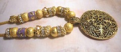 Beautiful one of a kind hand assembled necklace with gold tone beads & charms