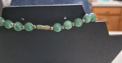 Green aventurine beads and a central orange stone necklace 18in