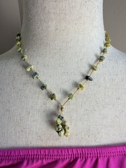 This is a handmade light green serpentine chip stone cord necklace