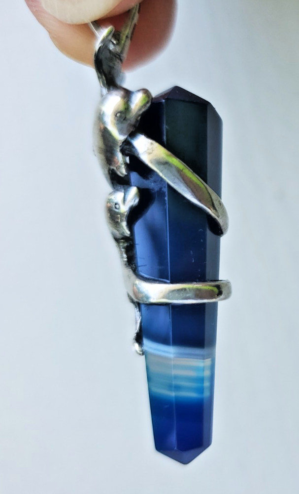 Sterling Silver Pendant of Dolphin pair clutching blue banded Agate crystal