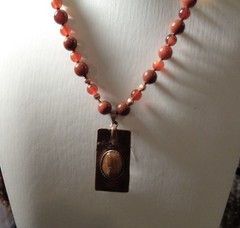 Artisan crafted,1 ¾ x ¾» hammered, antiqued copper pendant with applied Tiger ey