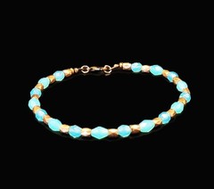 Uranium turquoise colored faceted glass beads with spacers 9″ stretch bracelet