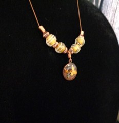 Artisan crafted, 15mm resin and dried flower pendant on strand of vintage yellow