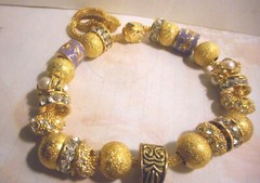 Beautiful one of a kind hand assembled necklace with gold tone beads & charms