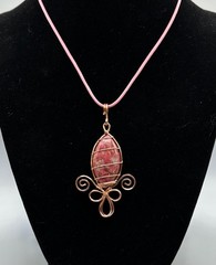 Fleur de lis pendant- Pink Thulite stone wrapped with copper wire, 18 in cord