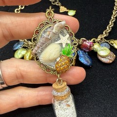 Adorned Crown Jewelry assemblage Pearl seascape bottle of sand shells necklace