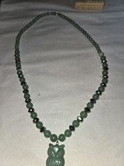 green aventurine beaded necklace features a hand-carved owl pendant accented…