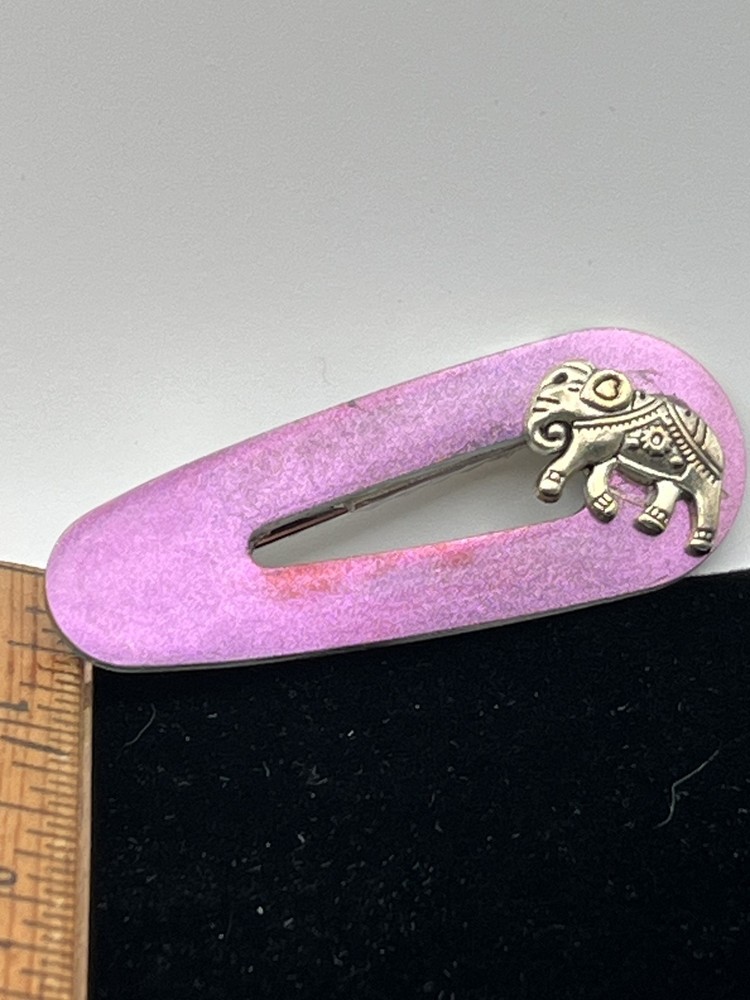 Iridescent, golden pink barrette embellished with an elephant