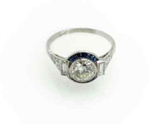 Features A Central 1.13CT Round European Cut CZ With Blue Sapphire Art Deco Ring