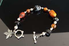 Beaded Bracelet Art Glass Leaf Charm Silver Tone Toggle Clasp Black Orange Red