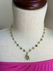 This is a handmade light green serpentine chip stone cord necklace