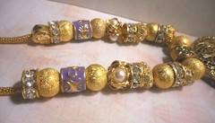 Beautiful one of a kind hand assembled necklace with gold tone beads & charms