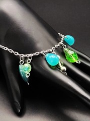 Uranium glass assorted bead charm? bracelet style on silver rolo chain 7″