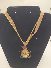 Necklace hand blown glass dog on ribbon. 9 in drop. Floral inside.