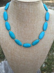 Necklace of Turquoise Blue Magnesite Puffy Oval Beads with Silver Tone Spacers