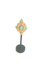 Handchrocheted brooch with turquoise and gold-dyed beads