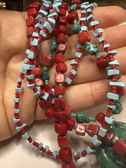 handmade red coral and turquoise beaded necklace with a carved green cinnabar