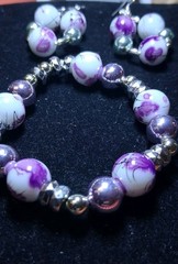 Handcrafted white and purple floral patterned Glass bead bracelet earring set.