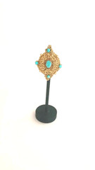 Handchrocheted brooch with turquoise and gold-dyed beads