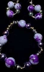Handcrafted white and purple floral patterned Glass bead bracelet earring set.