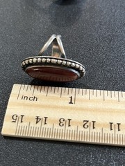 Sterling silver ring with reddish Brown oval center stone. Size 5-5 1/4.