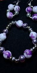Handcrafted white and purple floral patterned Glass bead bracelet earring set.