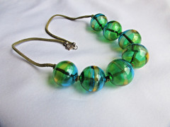 Hand made artisan beaded 22mm hollow hand -blown necklace 18″ on leather cord