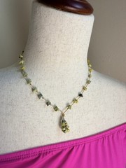 This is a handmade light green serpentine chip stone cord necklace