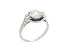 Features A Central 1.13CT Round European Cut CZ With Blue Sapphire Art Deco Ring
