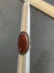 Sterling silver ring with reddish Brown oval center stone. Size 5-5 1/4.
