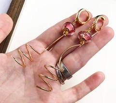 Unmatched earrings dangle, large spiral earrings gold tone