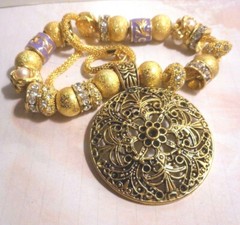 Beautiful one of a kind hand assembled necklace with gold tone beads & charms