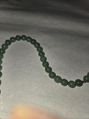 green aventurine beaded necklace features a hand-carved owl pendant accented…