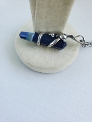 Sterling Silver Pendant of Dolphin pair clutching blue banded Agate crystal