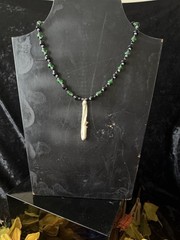 Armadillo leg bone necklace with green, black, gray, and silver glass beads