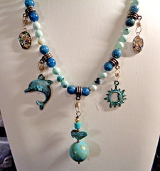 Artisan crafted, 19” charm pendant necklace. Ocean whirl and blue agate hand kno