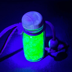 crushed uranium glass in a decorative jar with a wooden cap and leather cord