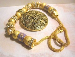 Beautiful one of a kind hand assembled necklace with gold tone beads & charms