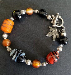 Beaded Bracelet Art Glass Leaf Charm Silver Tone Toggle Clasp Black Orange Red