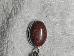Goldstone Pendant. Bezel Set In Handmade Rhodium Plated Mounting.