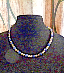 Artisan crafted, 18 1/2” faceted sodalite,sterling beads, hand knotted on silk.